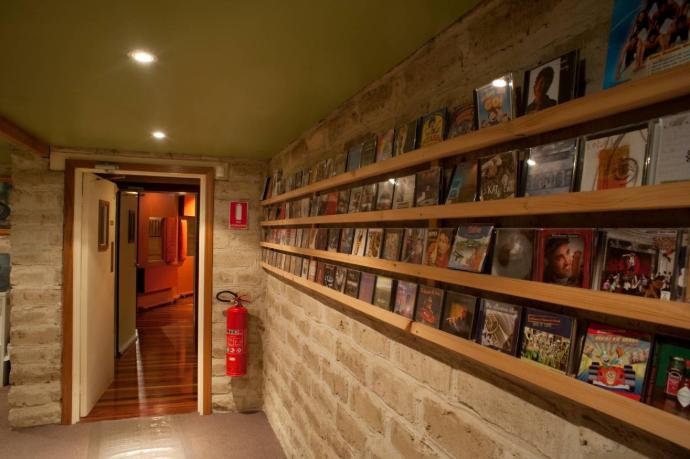 a wall of music cds leading to a studio